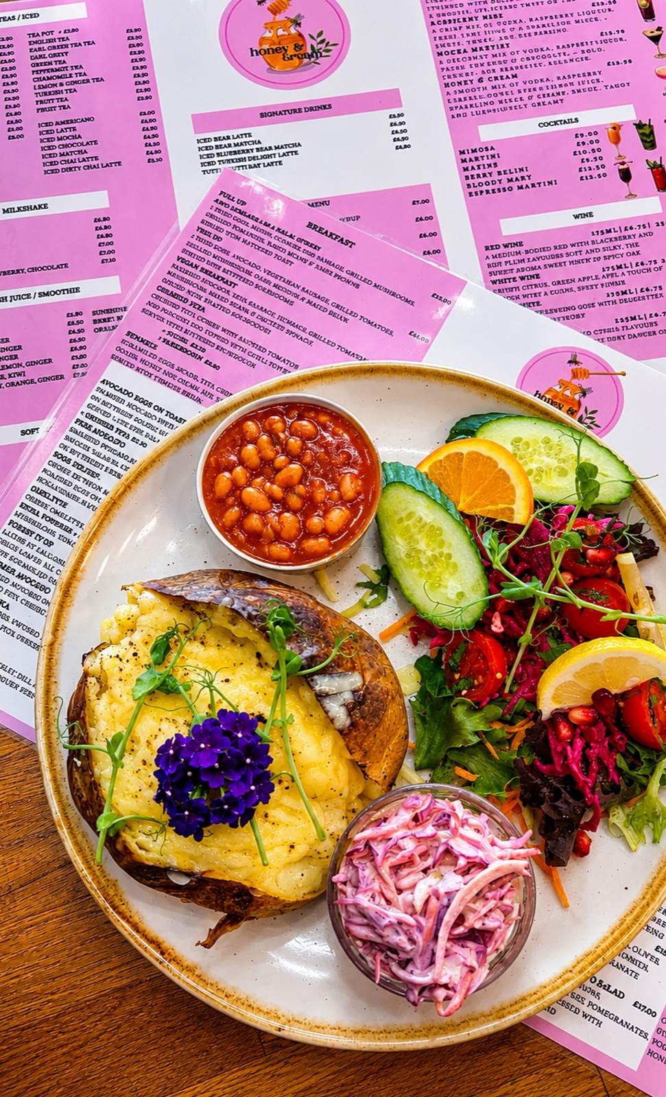 A colourful brunch plate with fresh salad, beans and slaw at Honey & Cream